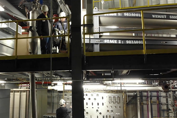 Men in hard hats, looking at equipment